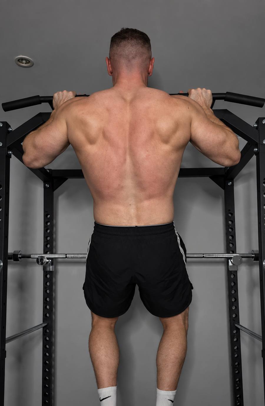 Neil Walsh doing a pull-up, showing back musculature